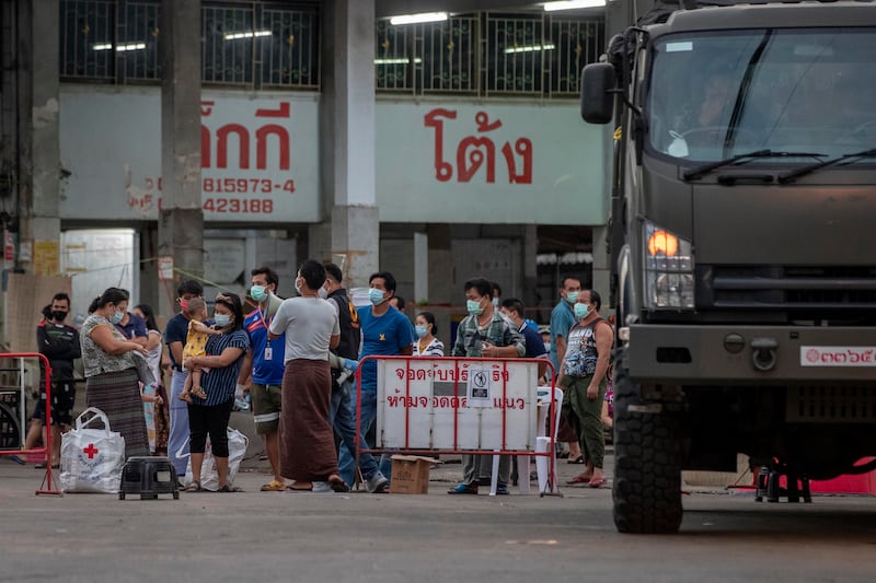 Migrant workers and their families are prepared to be taken to a field hospital for COVID-19 patients in Samut Sakhon, south of Bangkok, Thailand, Jan. 4, 2021.